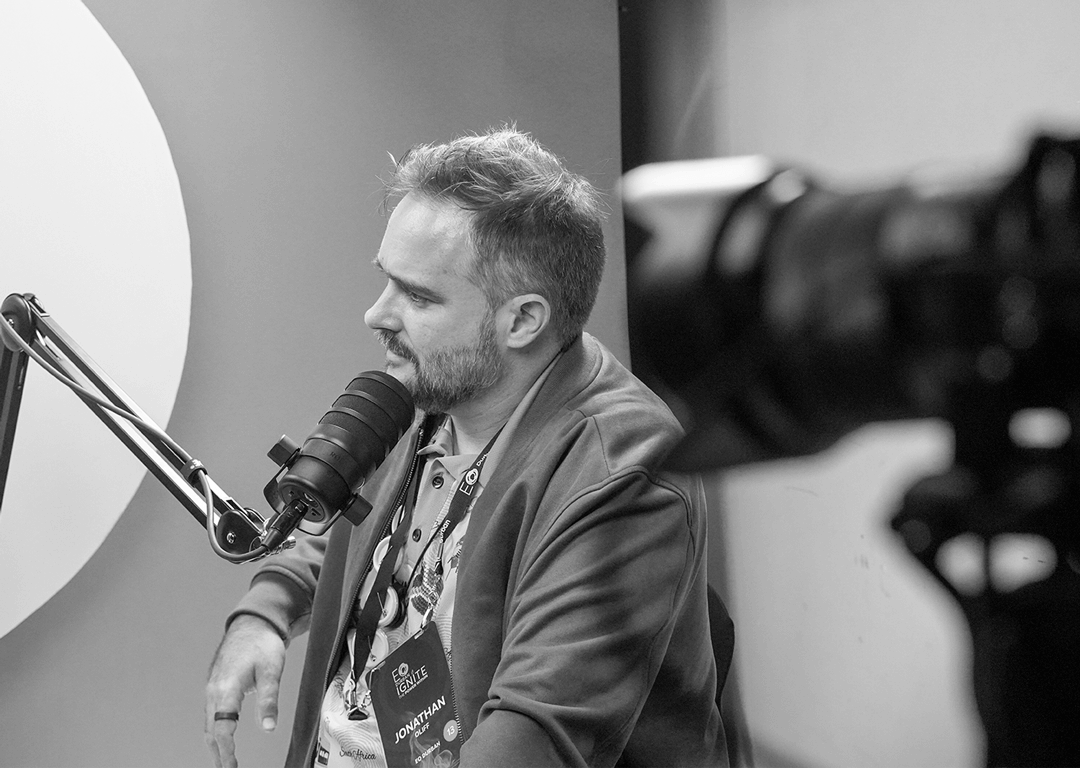 grayscale-photo-of-jonathan-oliff-shooting-in-a-podcasting-1
